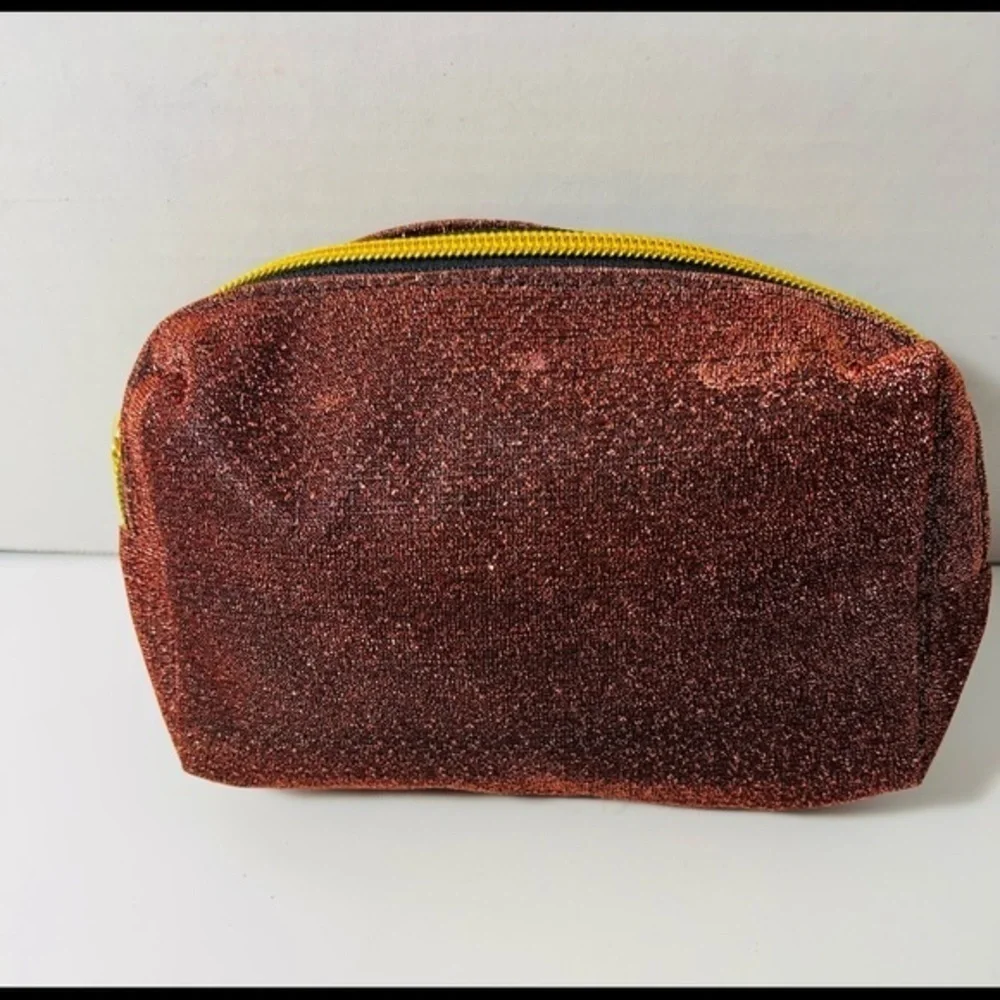 Shiny makeup pouch with fleur de lis symbol